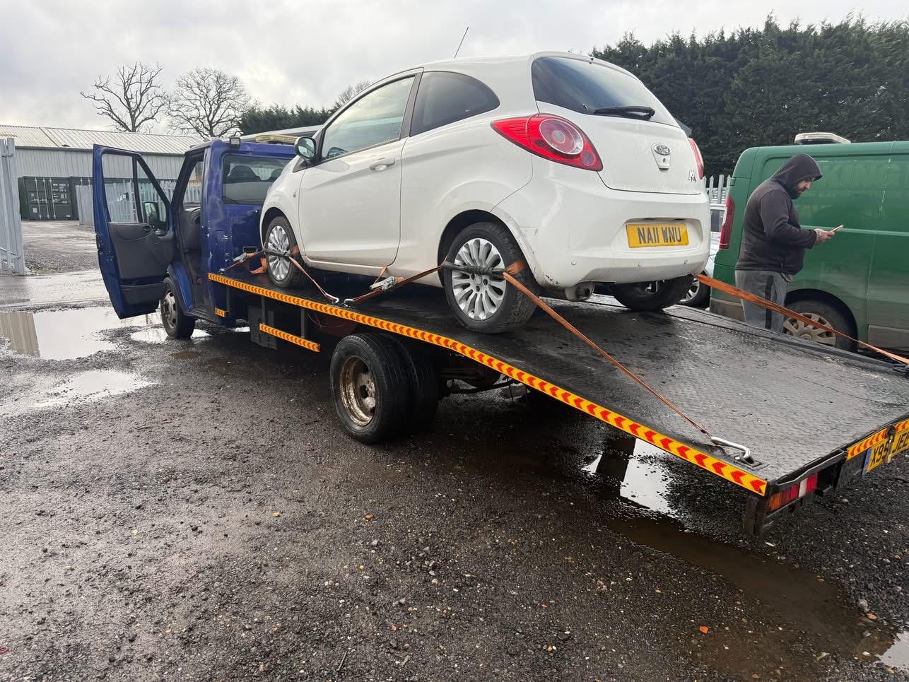 Technician performing basic maintenance on a recovery vehicle