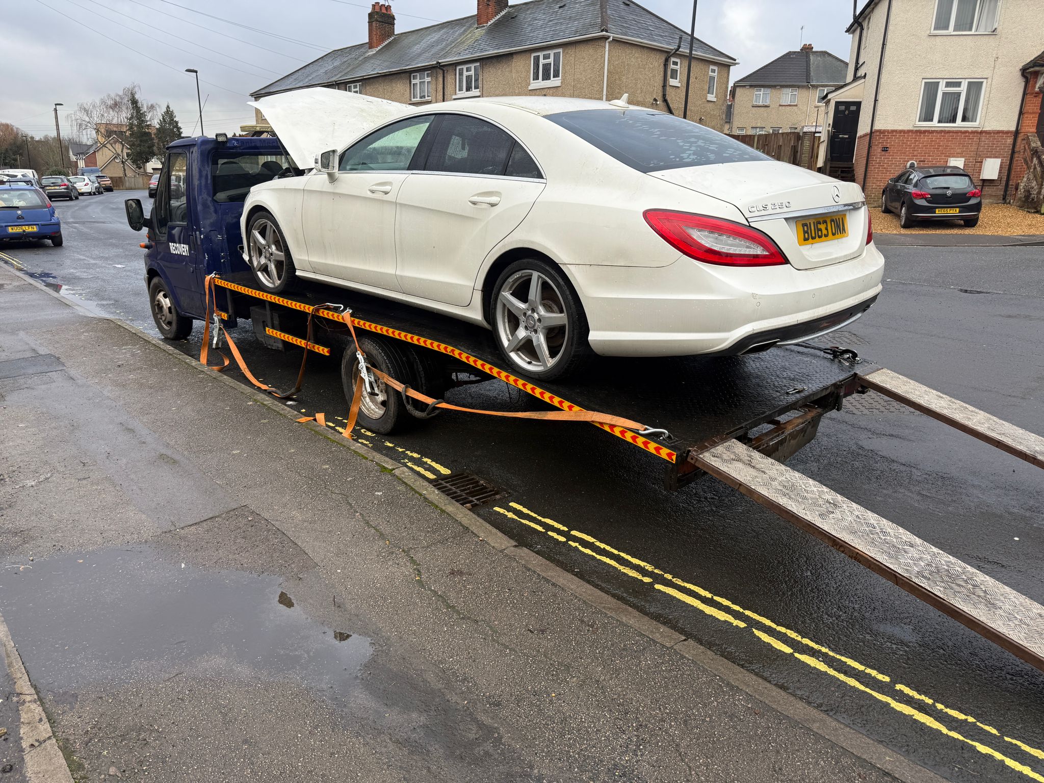 Technician jump-starting a vehicle at the roadside
