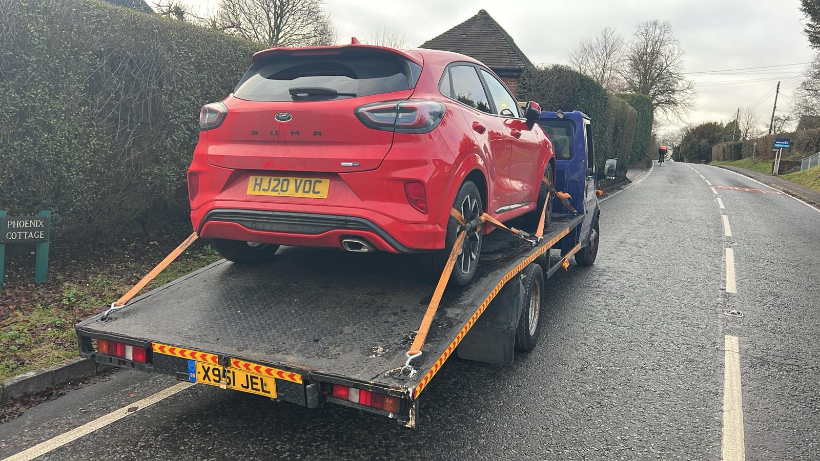 Recovery vehicle transporting a car for long-distance delivery