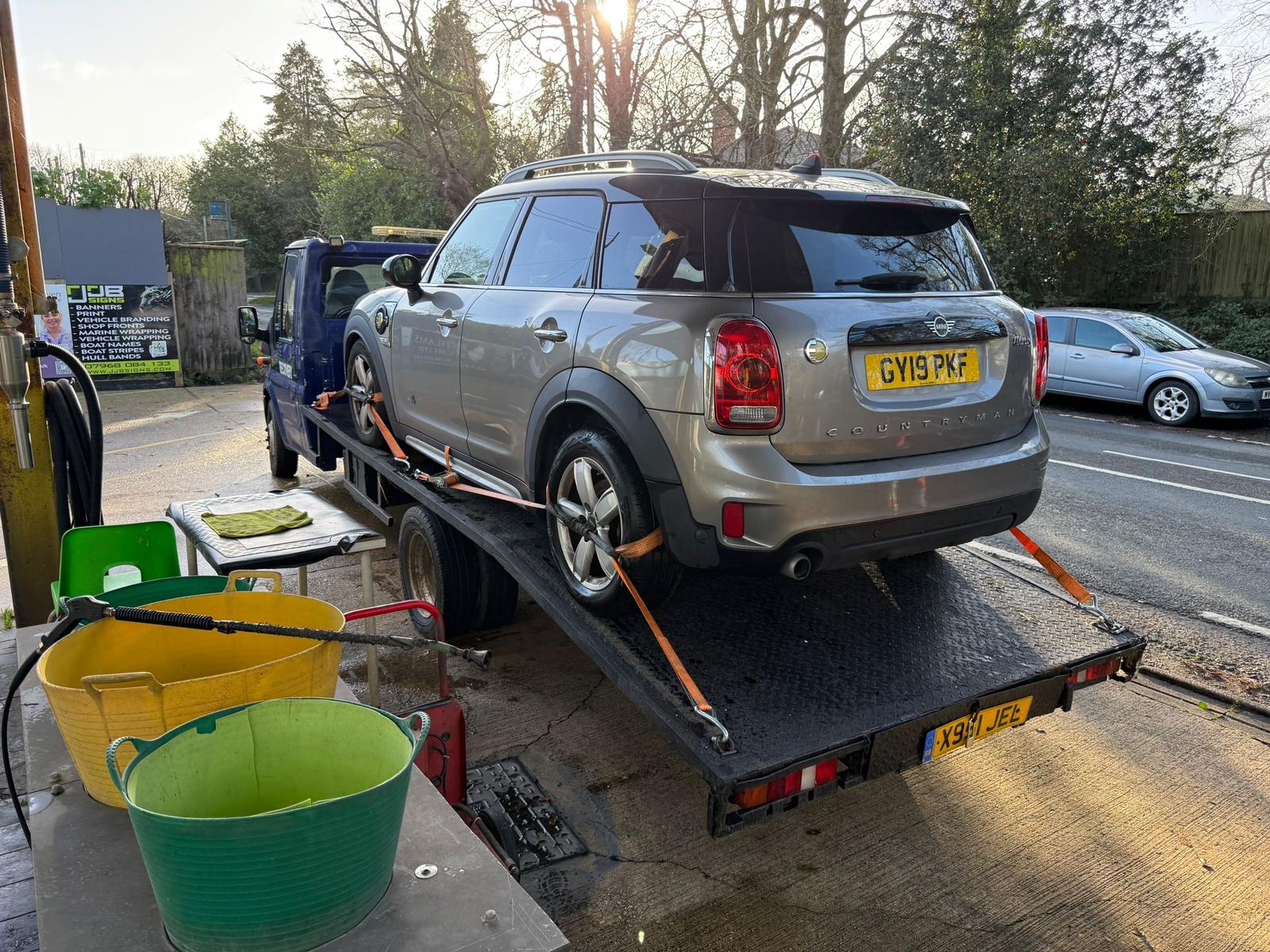 Technician unlocking a car for a customer after a lockout